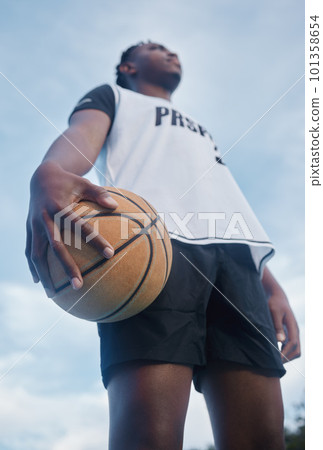 Basketball athlete ready for training, game and competition on sports court from below outdoor. Thinking, focus and fitness young black man with motivation, mindset and goal to play, win and have fun Basketball athlete ready for training, game and competition on sports court from below outdoor. Thinking, focus and fitness young black man with motivation, mindset and goal to play, win and have fun 101358654