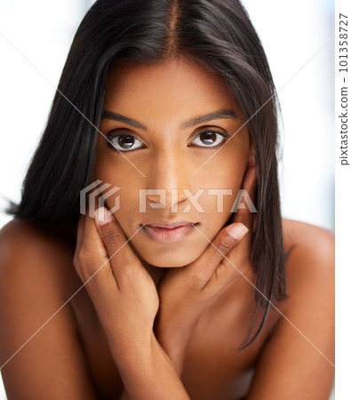.Portrait, beauty and skincare with an indian woman in her home, feeling beautiful or fresh. Face, hair and relax with an attractive young female in her apartment looking confident or feminine. .Portrait, beauty and skincare with an indian woman in her home, feeling beautiful or fresh. Face, hair and relax with an attractive young female in her apartment looking confident or feminine. 101358727