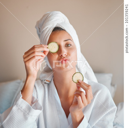 Eye mask, happy and portrait of a woman with cucumber for wellness, face care and skincare at home. Playful, home spa and a girl with food for facial hydration, nutrition and weekend relaxation 101359241