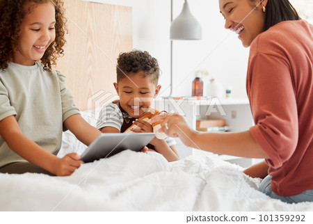 Mother, daughter and son on a tablet relaxing in their home, watching fun cartoons and spending time together. Happy family, on a digital device learning and playing a game in the childrens bedroom. Mother, daughter and son on a tablet relaxing in their home, watching fun cartoons and spending time together. Happy family, on a digital device learning and playing a game in the childrens bedroom. 101359292