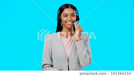 Call center, crm or Indian woman in studio for communication isolated on blue background. Customer services, mockup or friendly girl in headset helping, talking or explaining at technical support Call center, crm or Indian woman in studio for communication isolated on blue background. Customer services, mockup or friendly girl in headset helping, talking or explaining at technical support 101360154