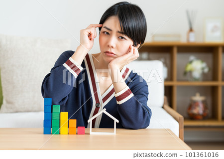 Young woman worried about mortgage Young woman worried about mortgage 101361016