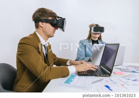 business persons with virtual reality headsets in meeting room at the office. business persons with virtual reality headsets in meeting room at the office. 101361023