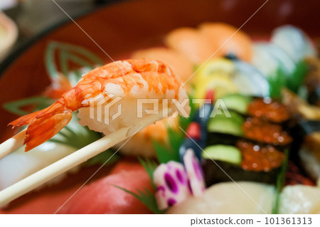 Hand-delivered nigiri sushi in a pail, shrimp Hand-delivered nigiri sushi in a pail, shrimp 101361313
