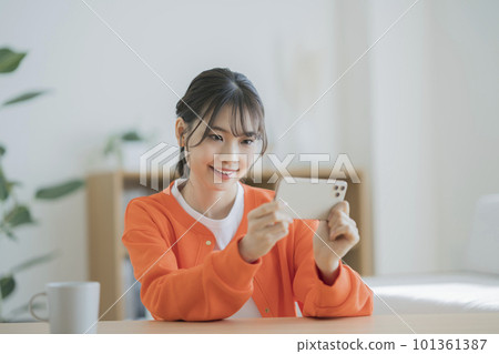 Young woman looking at a smartphone Young woman looking at a smartphone 101361387