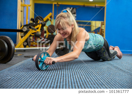 Exercise abdominal muscles at the gym using professional equipment Exercise abdominal muscles at the gym using professional equipment 101361777