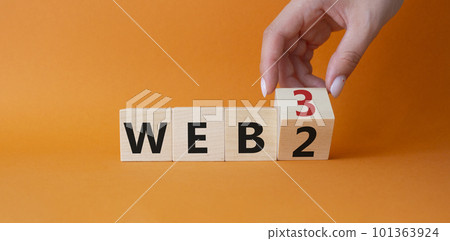 Web 3 vs Web 2 symbol. Businessman Hand turns cubes and changes the word web 2 to web 3. Beautiful orange background. Business concept. Copy space 101363924