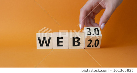 Web 3.0 vs Web 2.0 symbol. Hand turns cubes and changes the word web 2.0 to web 3.0. Beautiful orange background. Businessman hand. Business concept. Copy space 101363925