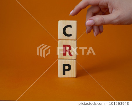 CRP - C-Reactive Protein Test symbol. Wooden cubes with word CRP. Doctor hand. Beautiful orange background. Medical and C-Reactive Protein Test concept. Copy space. 101363948