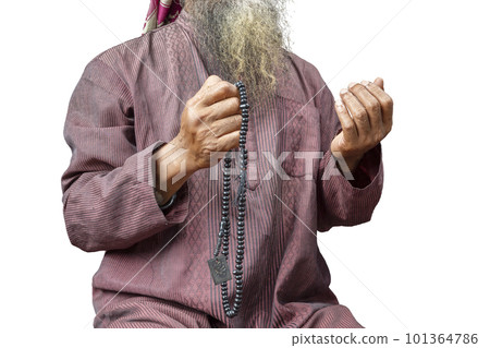 Muslim man with a beard wearing keffiyeh with agal praying with prayer beads on his hands Muslim man with a beard wearing keffiyeh with agal praying with prayer beads on his hands 101364786