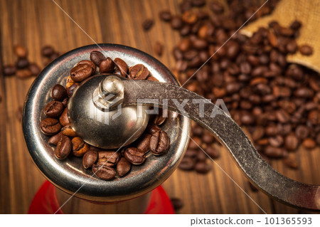 Coffee grinder and coffee beans closeup on vintage boards. Idea for making a coffee drink Coffee grinder and coffee beans closeup on vintage boards. Idea for making a coffee drink 101365593