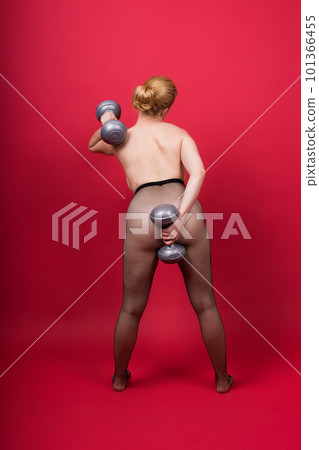 Seductive beautiful fitness female, athletic woman working out with dumbbells. Isolated in studio 101366455