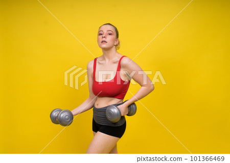 Seductive beautiful fitness female, athletic woman working out with dumbbells. Isolated in studio Seductive beautiful fitness female, athletic woman working out with dumbbells. Isolated in studio 101366469