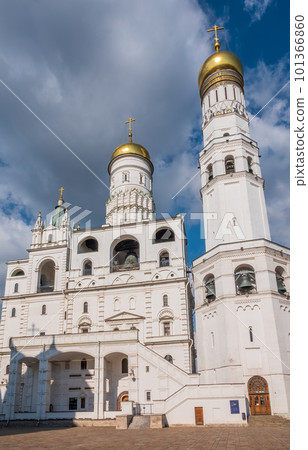 Ivan the Great Bell Tower, with Assumption Belfry on the right in Moscow Kremlin. Blue sky background with sunbeams 101366860