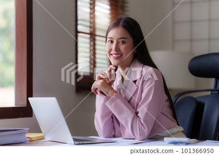 Asian Business person makes analysis and research financial report at office, analyzes profits. Accountant checks status of financial 101366950