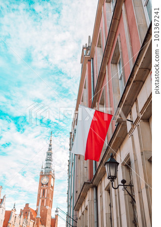 Poland Flag in blue sky and the centre of Gdansk in background Poland Flag in blue sky and the centre of Gdansk in background 101367241
