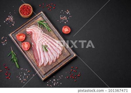 Delicious fresh pancetta with salt and spices cut into thin slices Delicious fresh pancetta with salt and spices cut into thin slices 101367471