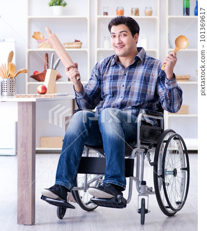 Disabled young man husband workin in kitchen Disabled young man husband workin in kitchen 101369617