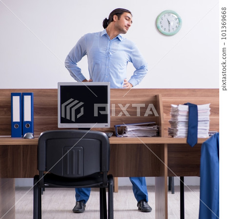 Young handsome businessman doing exercises at workplace 101369668