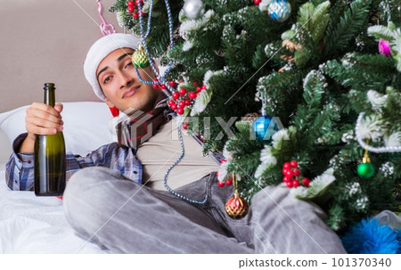 Man suffering hangover after christmas party 101370340