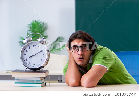 Young male student in front of green board Young male student in front of green board 101370747