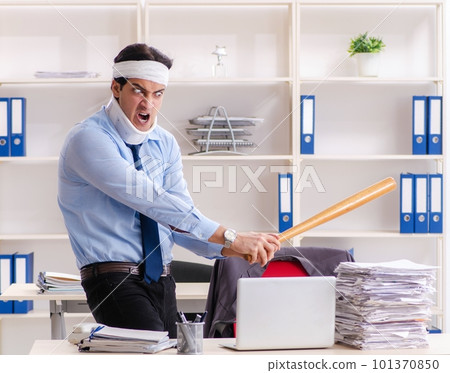 Young injured male employee working in the office 101370850
