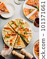 Traditional Italian pizza, vegetables, ingredients on a light background.Top view. a piece of pizza in the hand.Festive table. company of friends 101371661