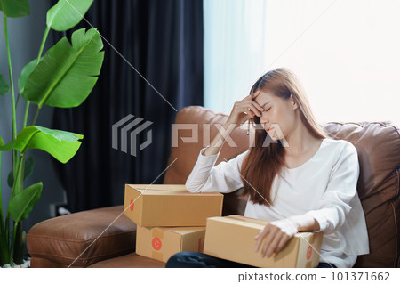 Starting small business entrepreneur of independent Asian woman showing her face worried about the sales of her business not reaching the target set. SME concepts. Starting small business entrepreneur of independent Asian woman showing her face worried about the sales of her business not reaching the target set. SME concepts. 101371662
