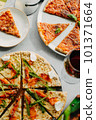 Traditional Italian pizza, vegetables, ingredients on a light background.Top view. a piece of pizza in the hand.Festive table. company of friends 101371664