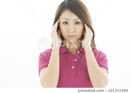 A woman holding down temple 101372494