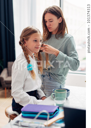 Mother Braids Her Daughter's Braid Before School Mother Braids Her Daughter's Braid Before School 101374313