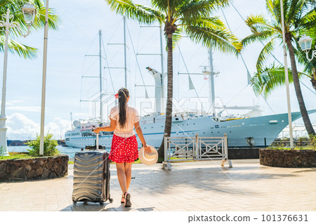 Cruise travel passenger going on board embarking ship with luggage suitcase. Woman tourist on Tahiti French Polynesia summer vacation. 101376631
