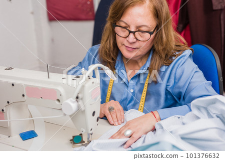 Professional dressmaker doing sustainable eco-friendly slow fashion. Cheerful hispanic chilean woman 101376632