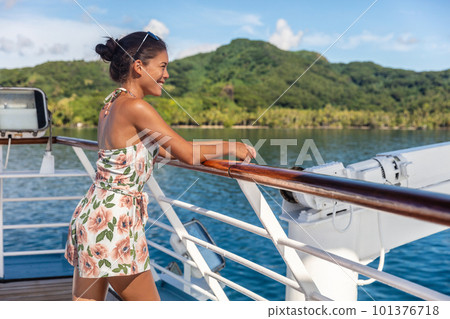 Cruise ship vacation woman relaxing in sun enjoying boat deck resting on railing of looking at Tahiti island landscape. Happy Asian girl on French Polynesia holiday travel. 101376718