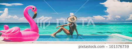 Vacation swimming pool banner luxury travel background woman relaxing by infinity overwater bungalow with pink flamingo float fun holiday concept panorama. 101376739