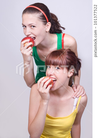 two girls with apples 101377522