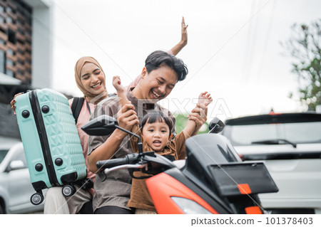 excited asian muslim family riding motorbike scooter 101378403