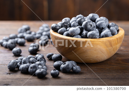 Fresh blueberry in wooden bowl. Concept of healthy and dieting eating. Fresh blueberry in wooden bowl. Concept of healthy and dieting eating. 101380700