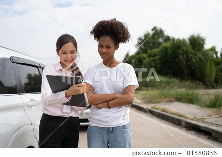Women drivers Talk to Insurance Agent for examining damaged car and customer checks on the report claim form after an accident. Concept of insurance, advice auto repair shop and car traffic accidents. Women drivers Talk to Insurance Agent for examining damaged car and customer checks on the report claim form after an accident. Concept of insurance, advice auto repair shop and car traffic accidents. 101380836