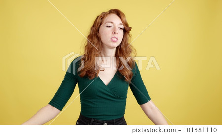 Woman with redhead hair gesturing that she is forgetting something 101381110