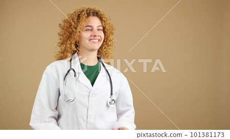Female doctor looking aside with the arms crossed Female doctor looking aside with the arms crossed 101381173