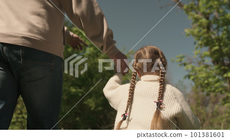 father leads child by hand outdoors. happy family park. dad daughter go walk holding hands. chidhood dream. kid with dad picnic. little child weekend nature with man father. teamwork. joint vacation father leads child by hand outdoors. happy family park. dad daughter go walk holding hands. chidhood dream. kid with dad picnic. little child weekend nature with man father. teamwork. joint vacation 101381601