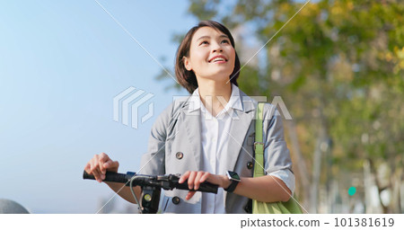woman walking with electric scooter woman walking with electric scooter 101381619