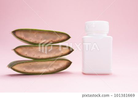 Green Fresh Juicy Aloe Vera Slice With White Plastic Bottle Of Medicine, Herbal Capsule, Pills, Vitamins On Pink Background. Pharmacy, Cosmetics, Natural Medicine, Product. Horizontal Plane, Closeup Green Fresh Juicy Aloe Vera Slice With White Plastic Bottle Of Medicine, Herbal Capsule, Pills, Vitamins On Pink Background. Pharmacy, Cosmetics, Natural Medicine, Product. Horizontal Plane, Closeup 101381669
