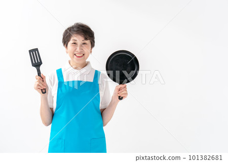 Woman cooking in apron Woman cooking in apron 101382681