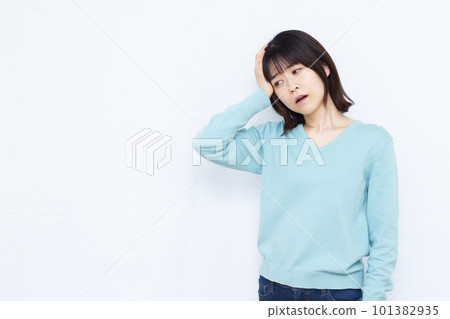 A woman in her thirties who has a headache A woman in her thirties who has a headache 101382935