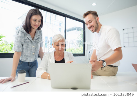 Senior female manager introducing work and presenting jobs to coworker using laptop. 101383049