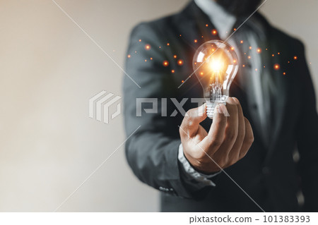 Idea innovation concept, man holding light bulb illuminated. energy creative learning genius. 101383393