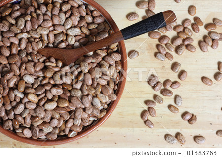 Dry Pinto Beans in Clay Bowl With Wooden Spoon in Rustic Kitchen Dry Pinto Beans in Clay Bowl With Wooden Spoon in Rustic Kitchen 101383763