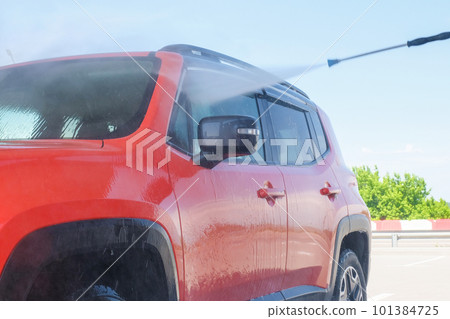 Car wash at a car wash under high water pressure Car wash at a car wash under high water pressure 101384725